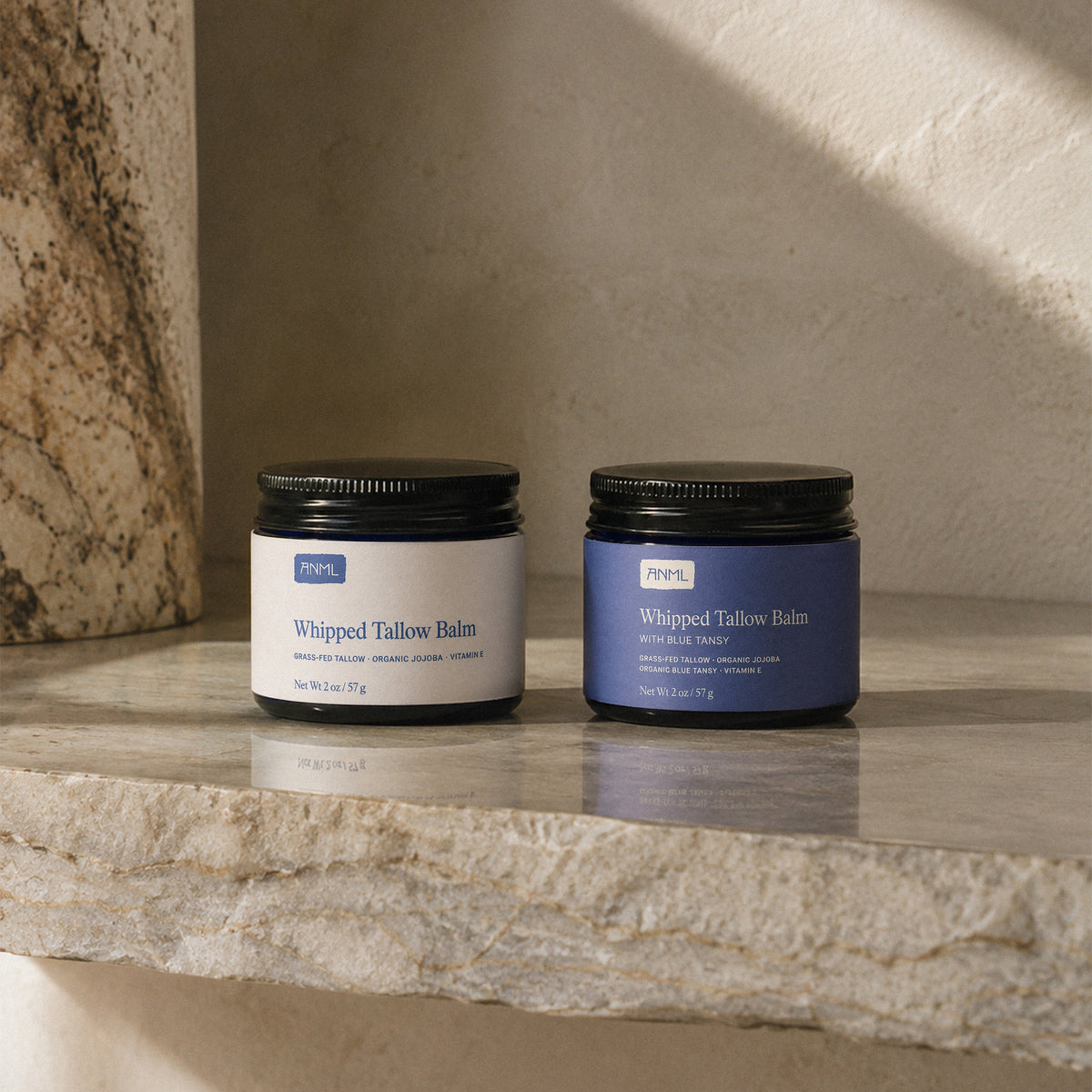 Two whipped tallow balm jars, one pale blue and one blue