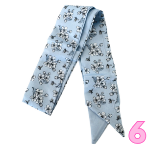 Women’s printed scarf in light blue with navy outlined floral bow motifs