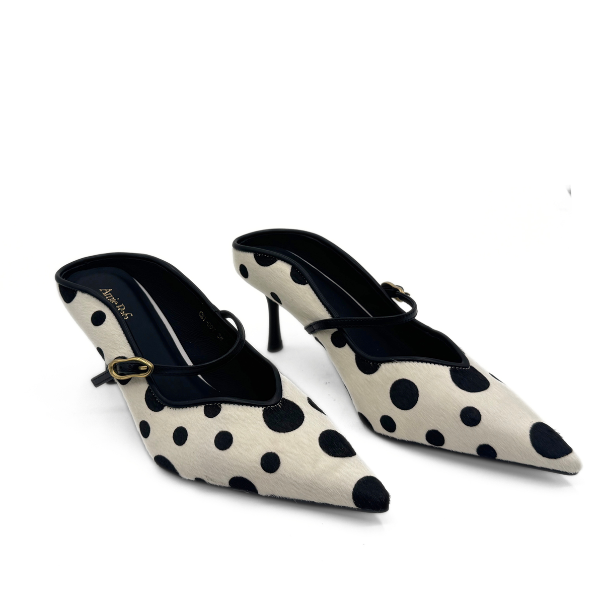 Pair of polka-dot pony hair pumps with gold buckle detail and black lining.