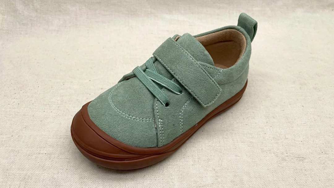 Kids’ light green low-top barefoot sneakers with lace-up front and brown rubber sole