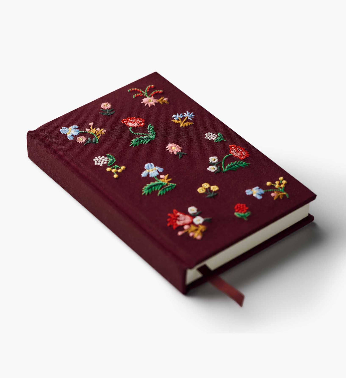 Mini embroidered journal angled view with burgundy cover, colorful floral embroidery, ribbon