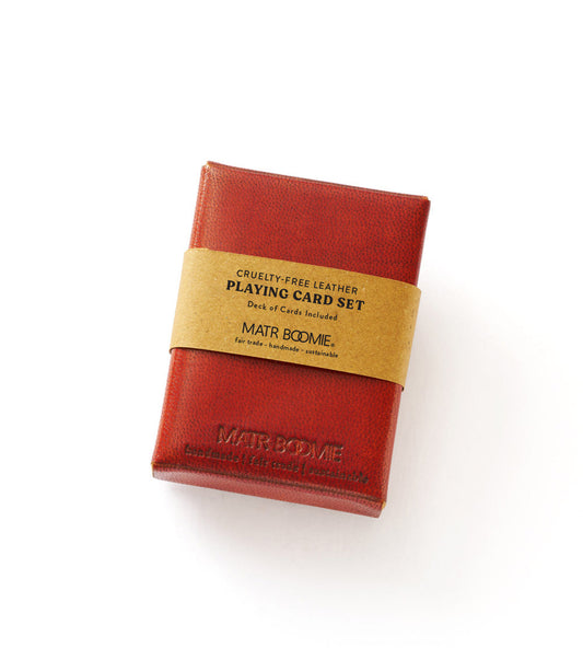 Red embossed leather playing card set with tan band label and gold lettering