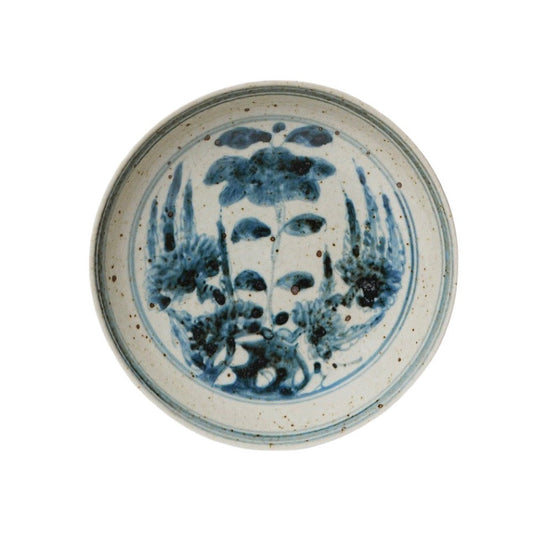 Small round porcelain dish with blue-and-white floral bouquet design and rim