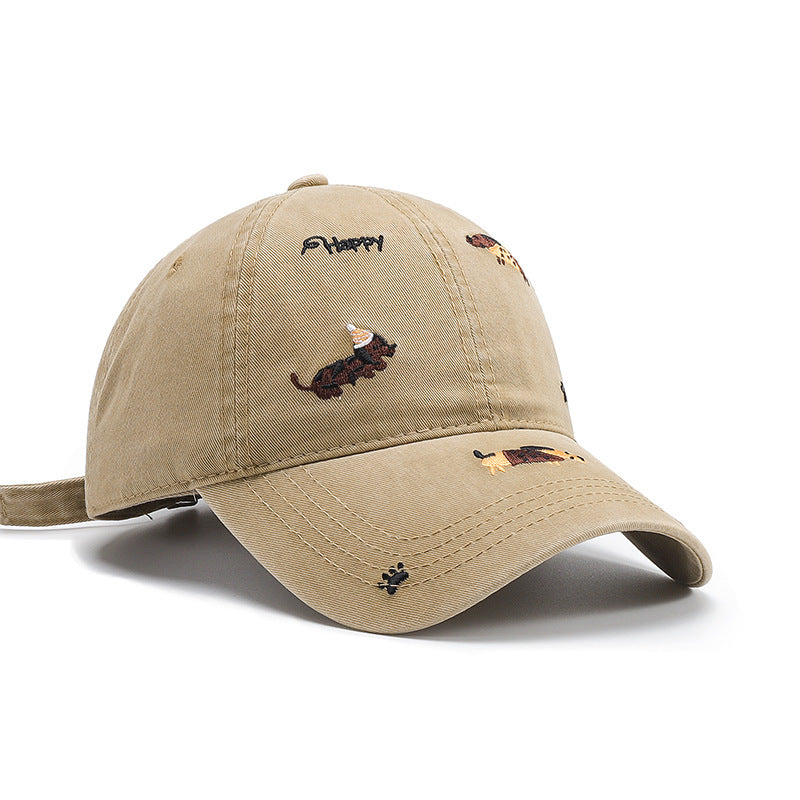 Angled view of a khaki baseball cap with curved brim and embroidered animal motifs
