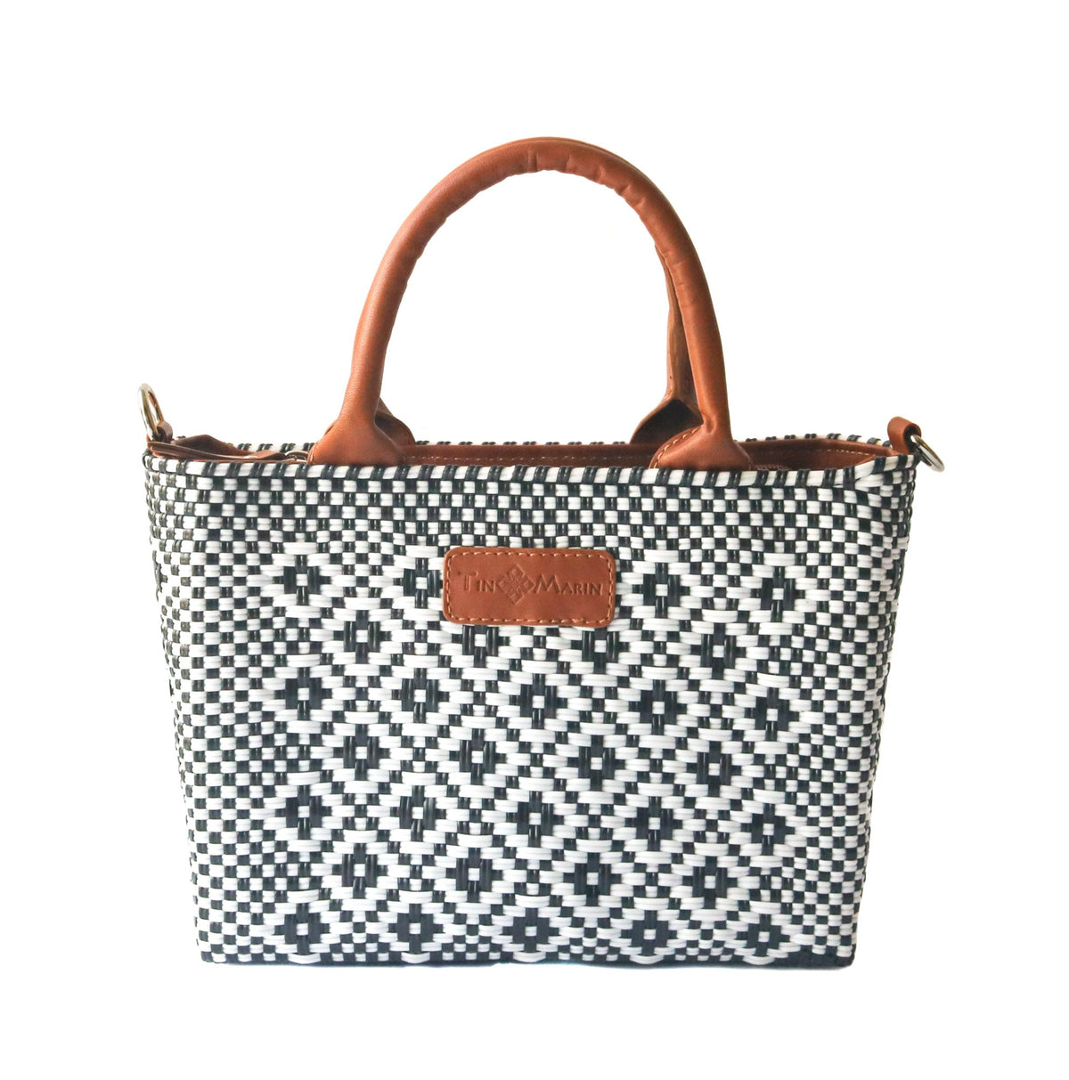 Small woven crossbody bag, black-and-white weave with tan leather handles and logo patch.