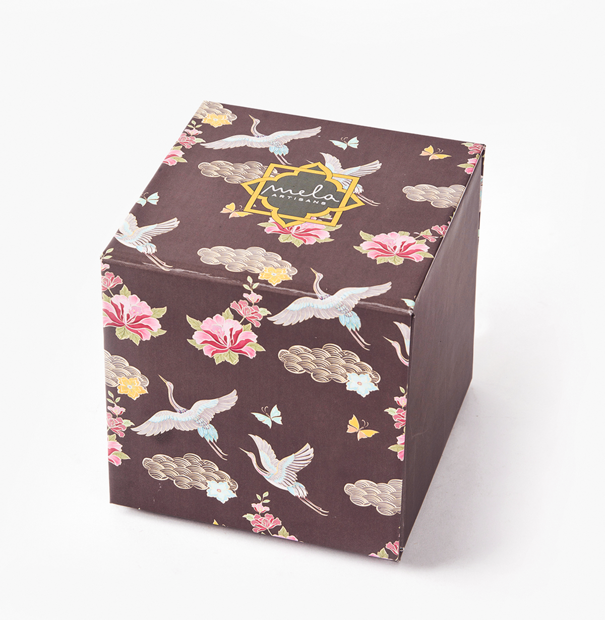 Decorative cube gift box in dark brown with floral and crane design, “mela” badge