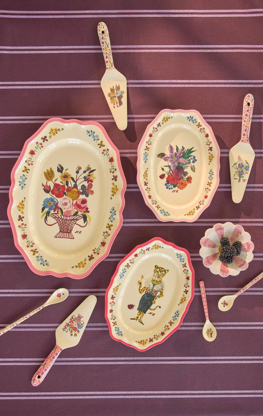 Set of small pink-edged melamine serving dishes with floral and basket prints
