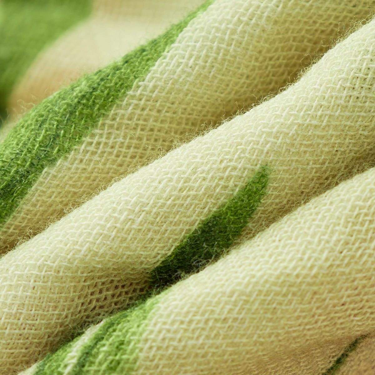 Woven towel fabric with crisscross texture and green-and-cream tulip pattern