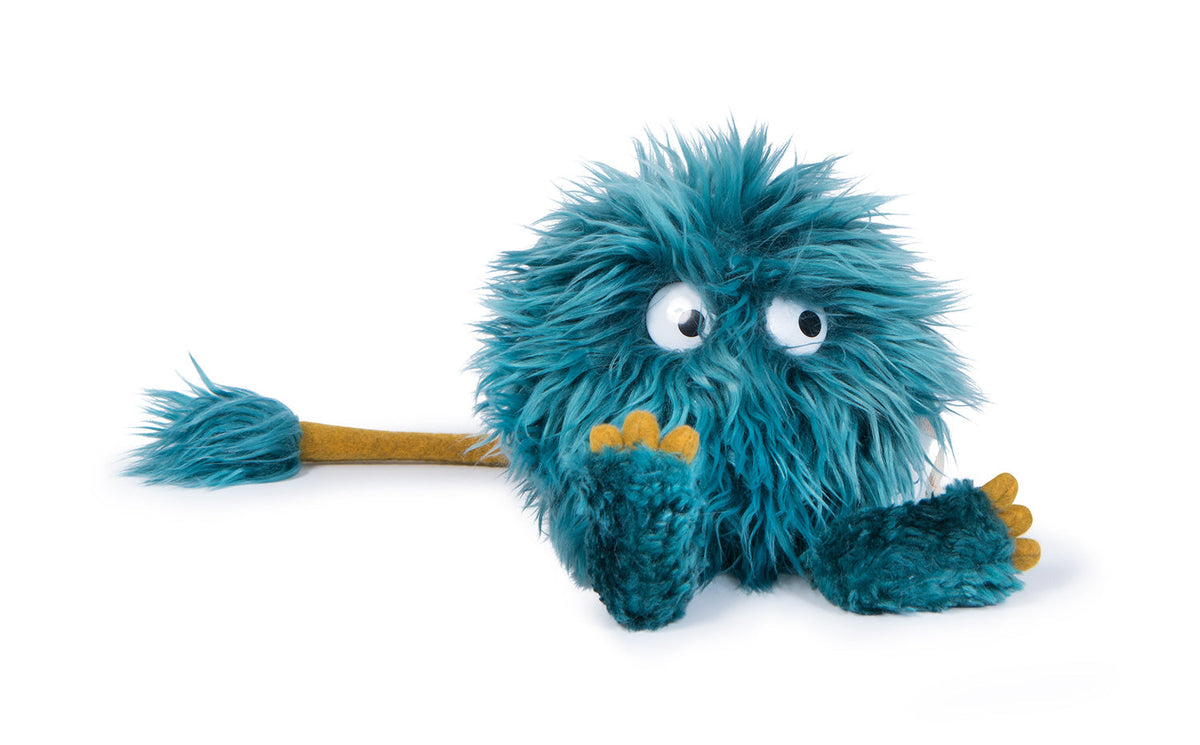 Choukette blue shaggy plush monster with googly eyes, yellow toes and a long tail