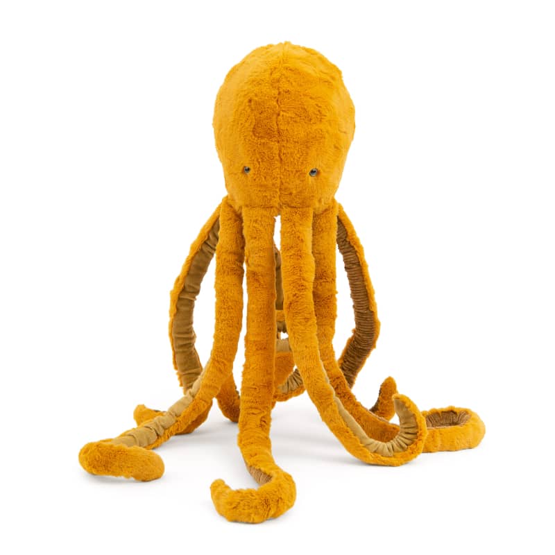 Large golden plush octopus with upright head, long tentacles, and stitched eyes