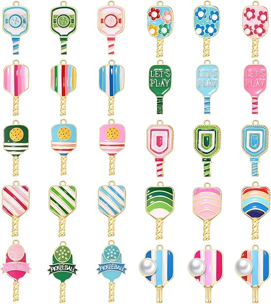 Rows of colorful pickleball charms with paddle, ball, floral, and striped designs and gold-tone loops.