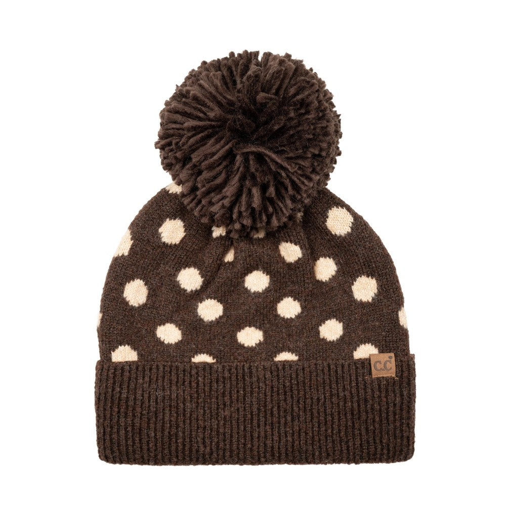 Polka dot knit beanie with brown cuff, dark pom, and white dots
