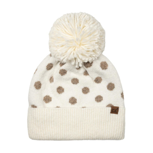 Polka dot knit beanie with cream cuff, white pom, and tan dots