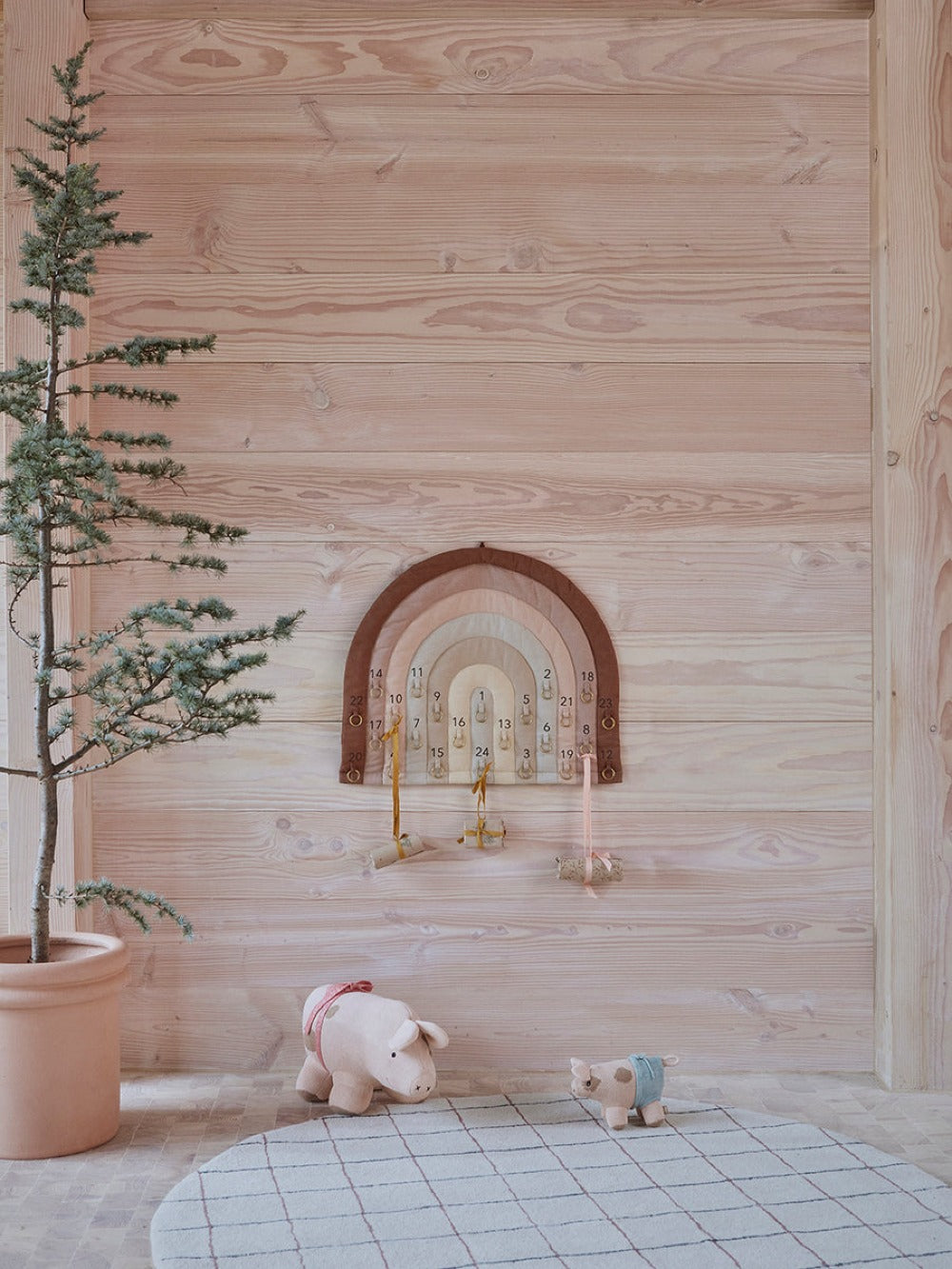 Rainbow arch advent calendar wall display with numbered slots and hanging charms