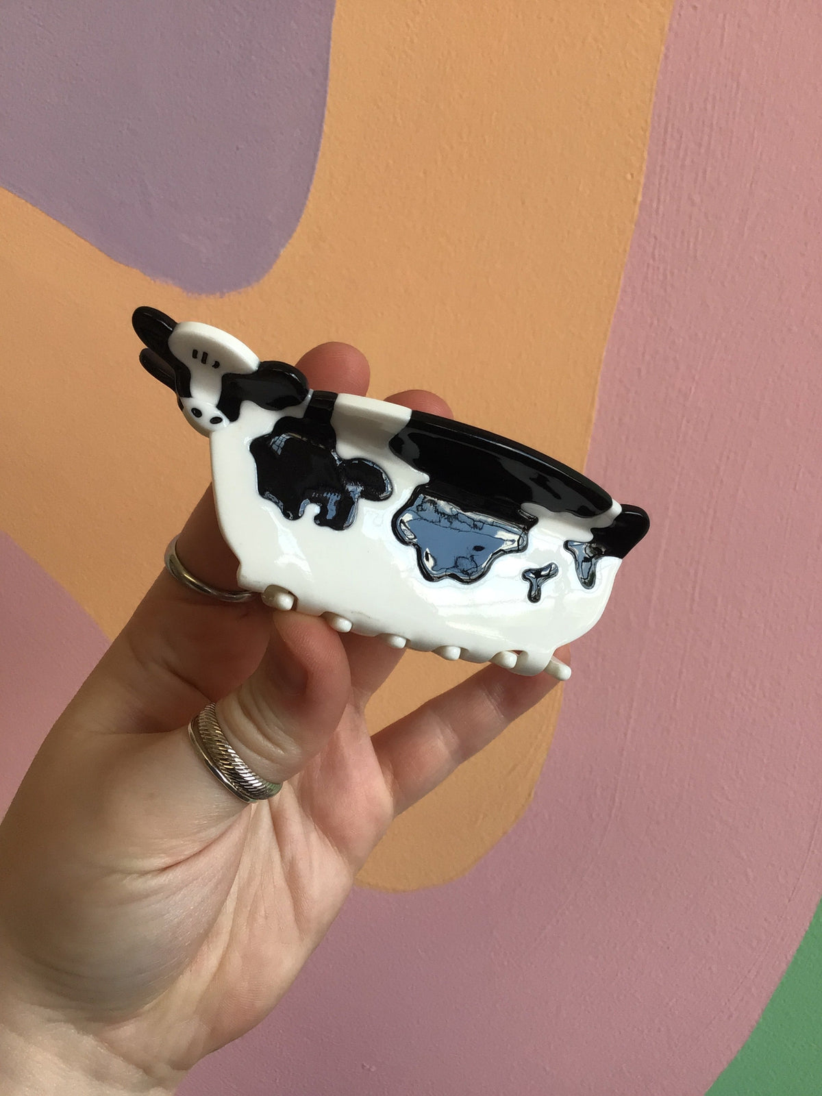 Cow animal hair claw clip, black-and-white body with blue face patch details
