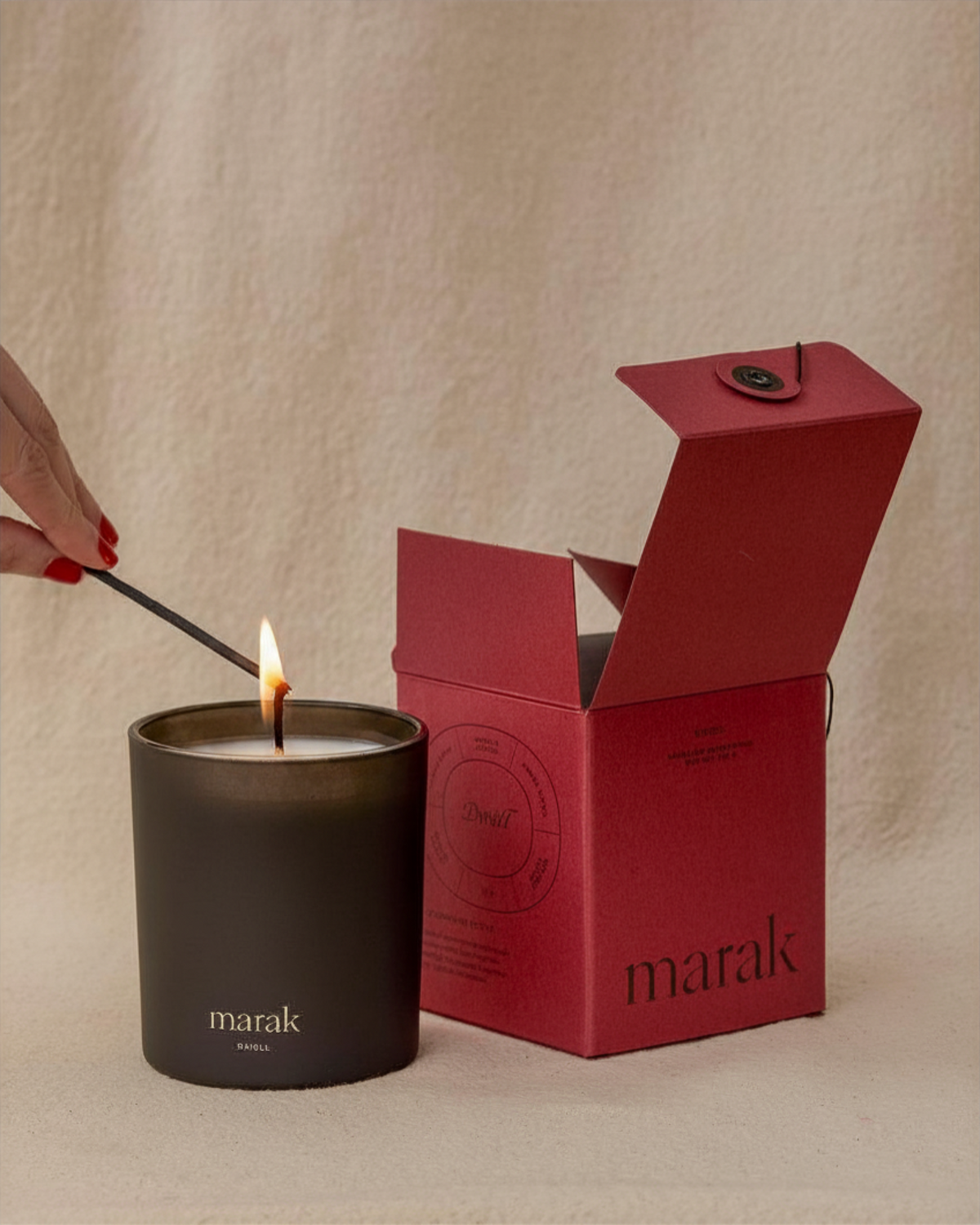 Lit marak scented candle in matte dark cup with red gift box