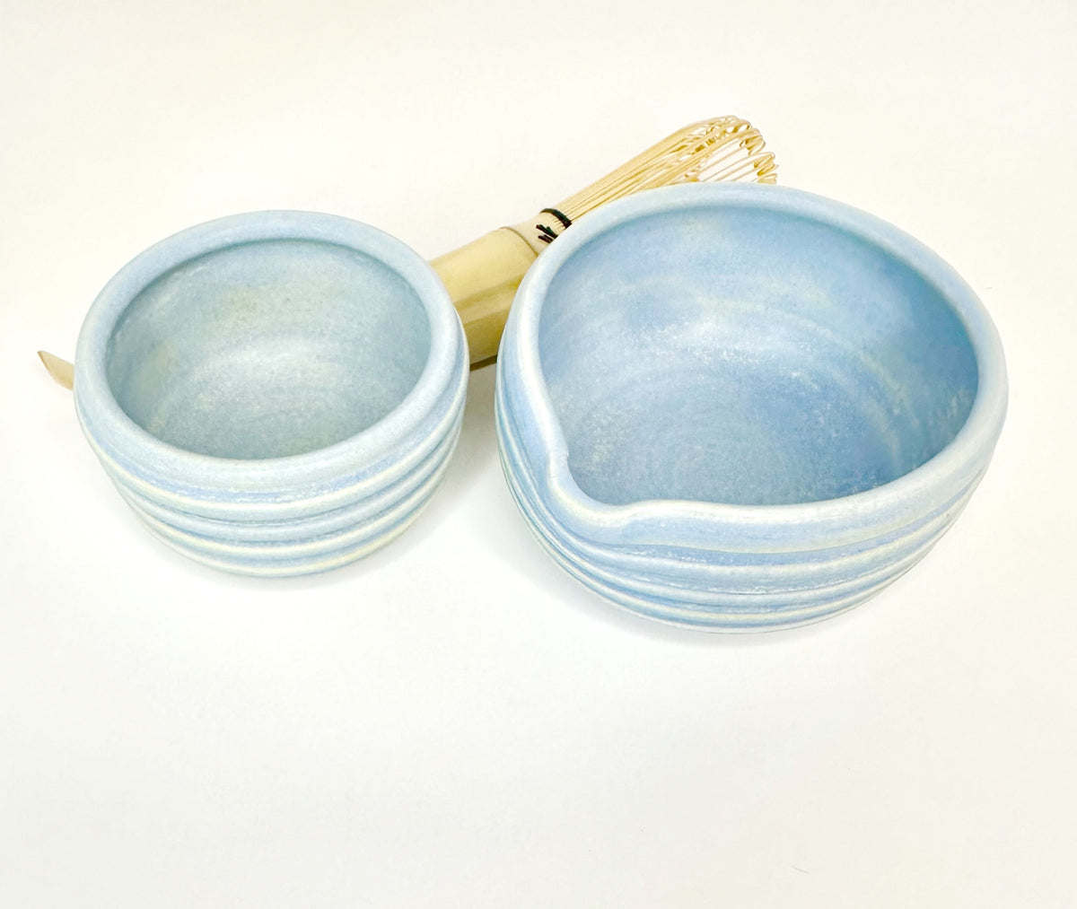 Blue matcha bowl set with large bowl, small cup, and bamboo whisk