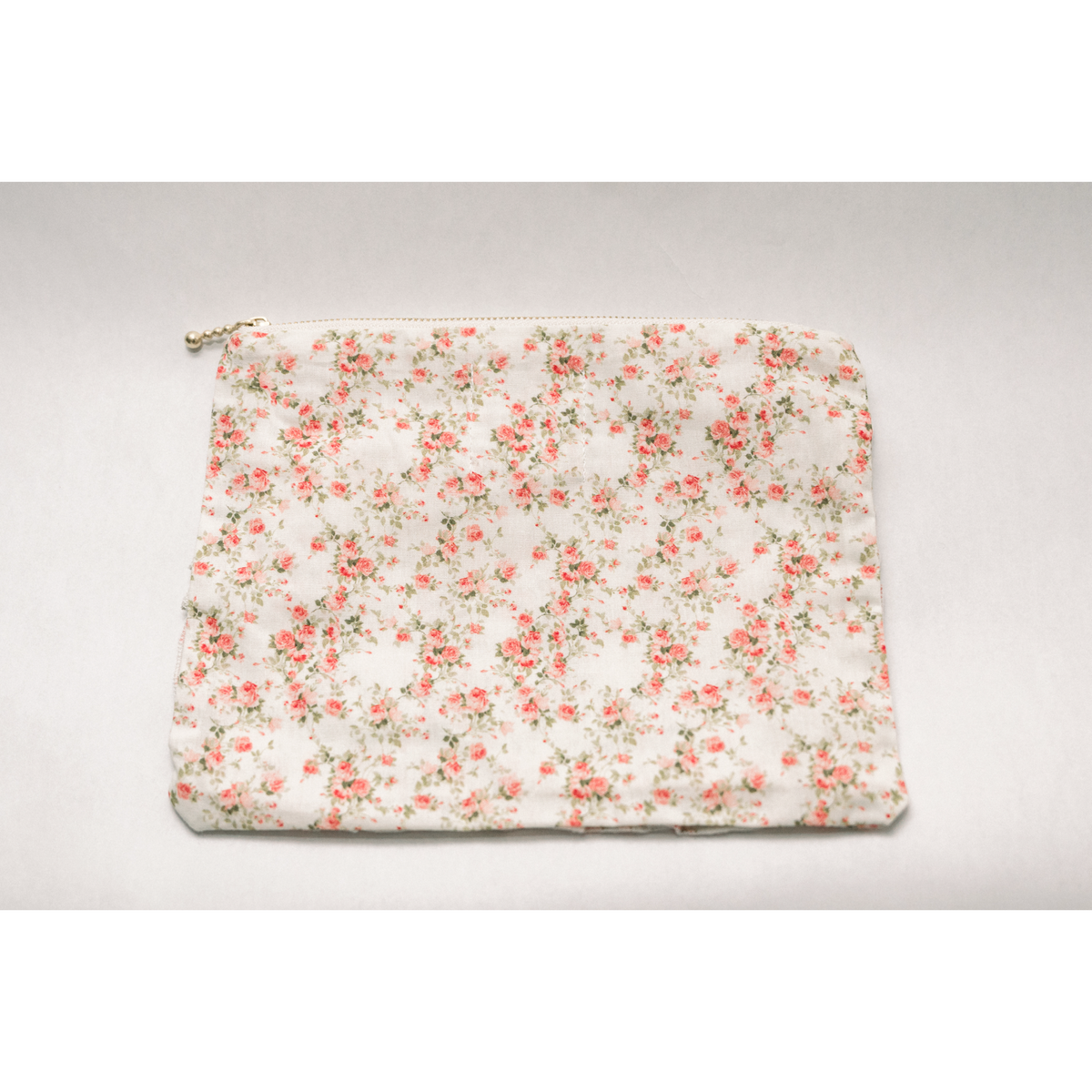 White floral ruffle zip pouch with metal zipper pull and pleated front