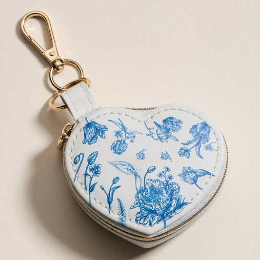 Heart-shaped jewelry travel case with blue floral print and keychain loop
