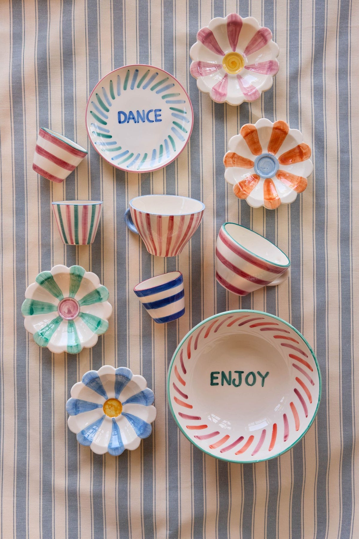 Ceramic tea cup set with striped designs in pink and blue