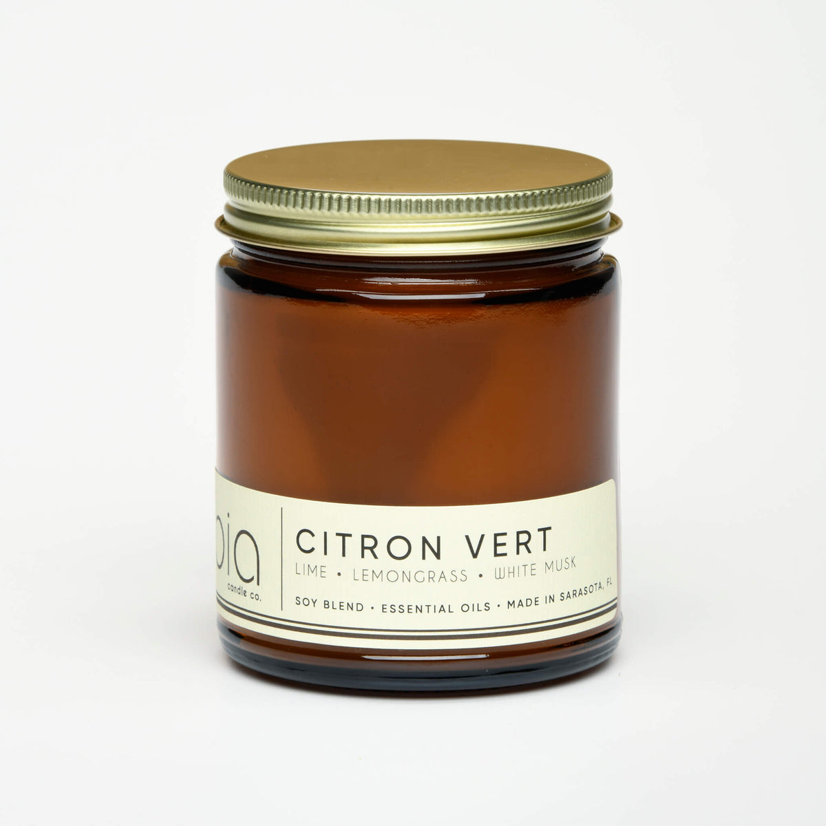 Amber glass soy blend candle jar with green metal lid and Citron Vert label
