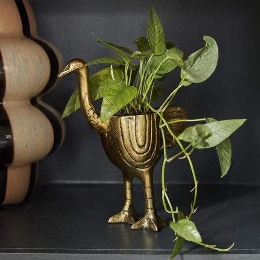 Antique gold ostrich-shaped decorative planter with green stems spilling from top