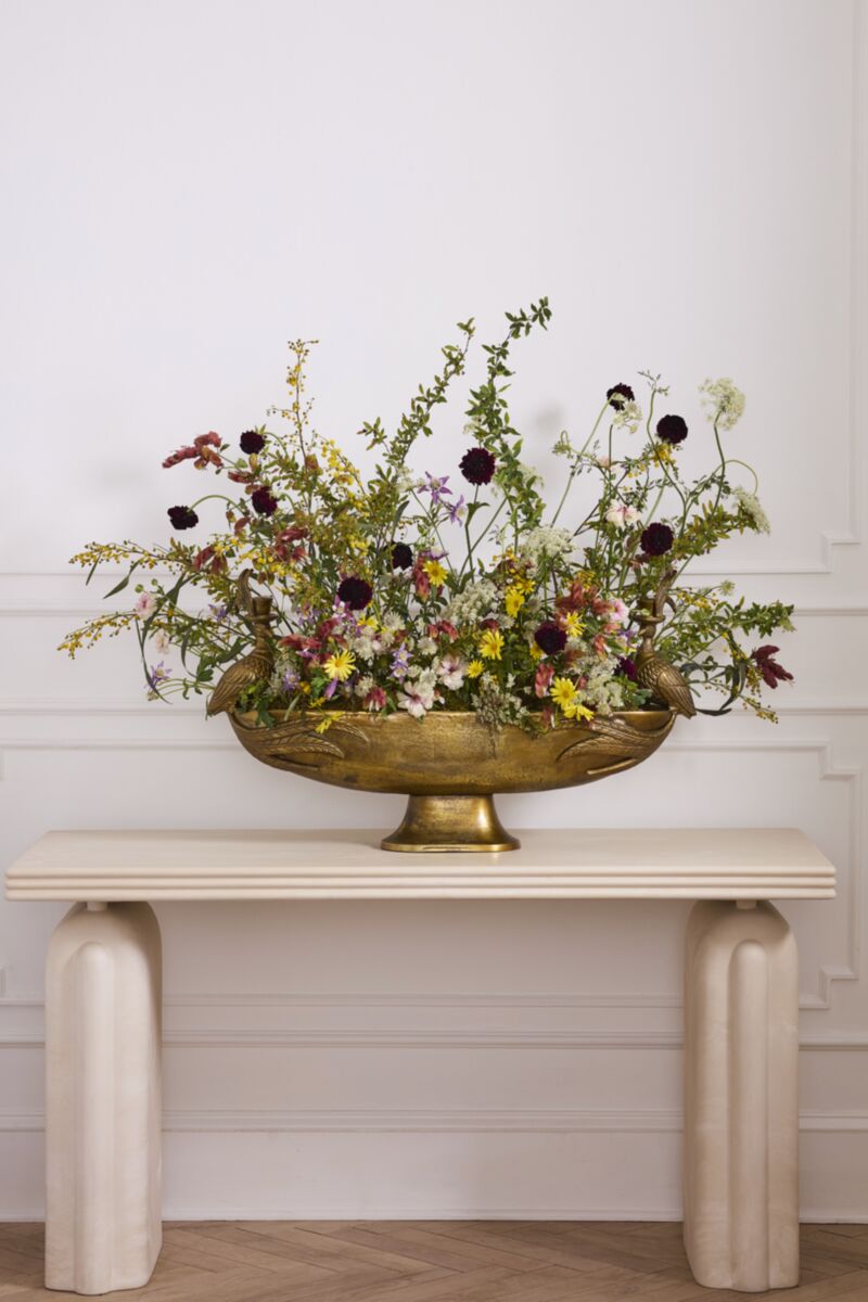 Decorative gold-tone footed bowl floral centerpiece with abundant mixed flowers