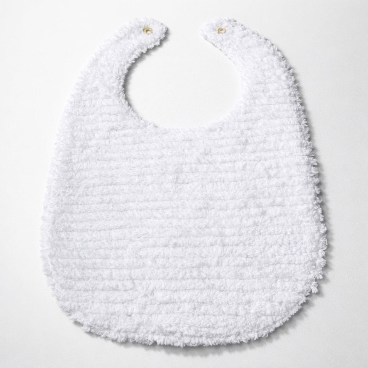 White terry-textured baby bib with snap button at top and fringed bottom hem