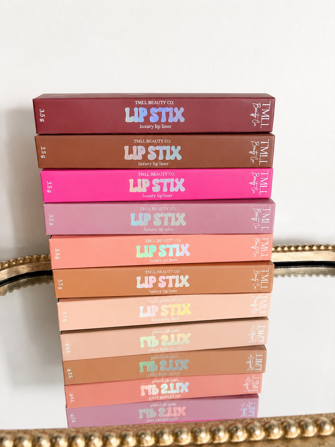 Set of luxury lip liner pencils in assorted colors, shown in stacked boxes.