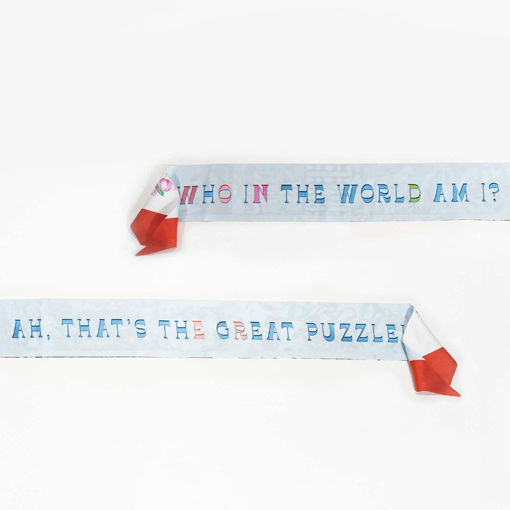 Silk twilly scarf with printed phrases on light blue band and orange-red knot tips