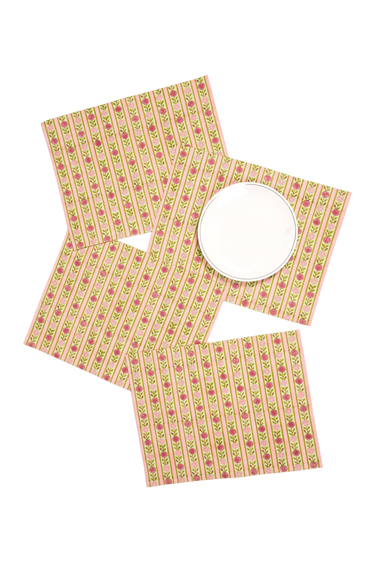 Pink floral striped placemats arranged with round plate on one