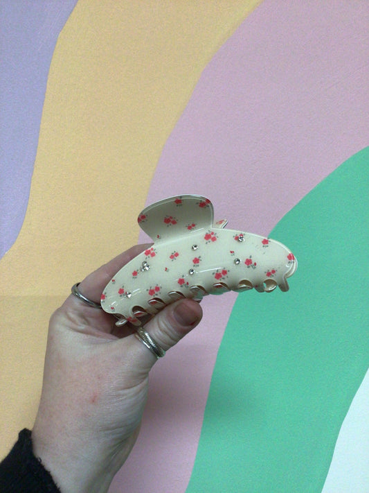 Cream toile hair claw clip with pink-red floral pattern and small clear sparkle dots
