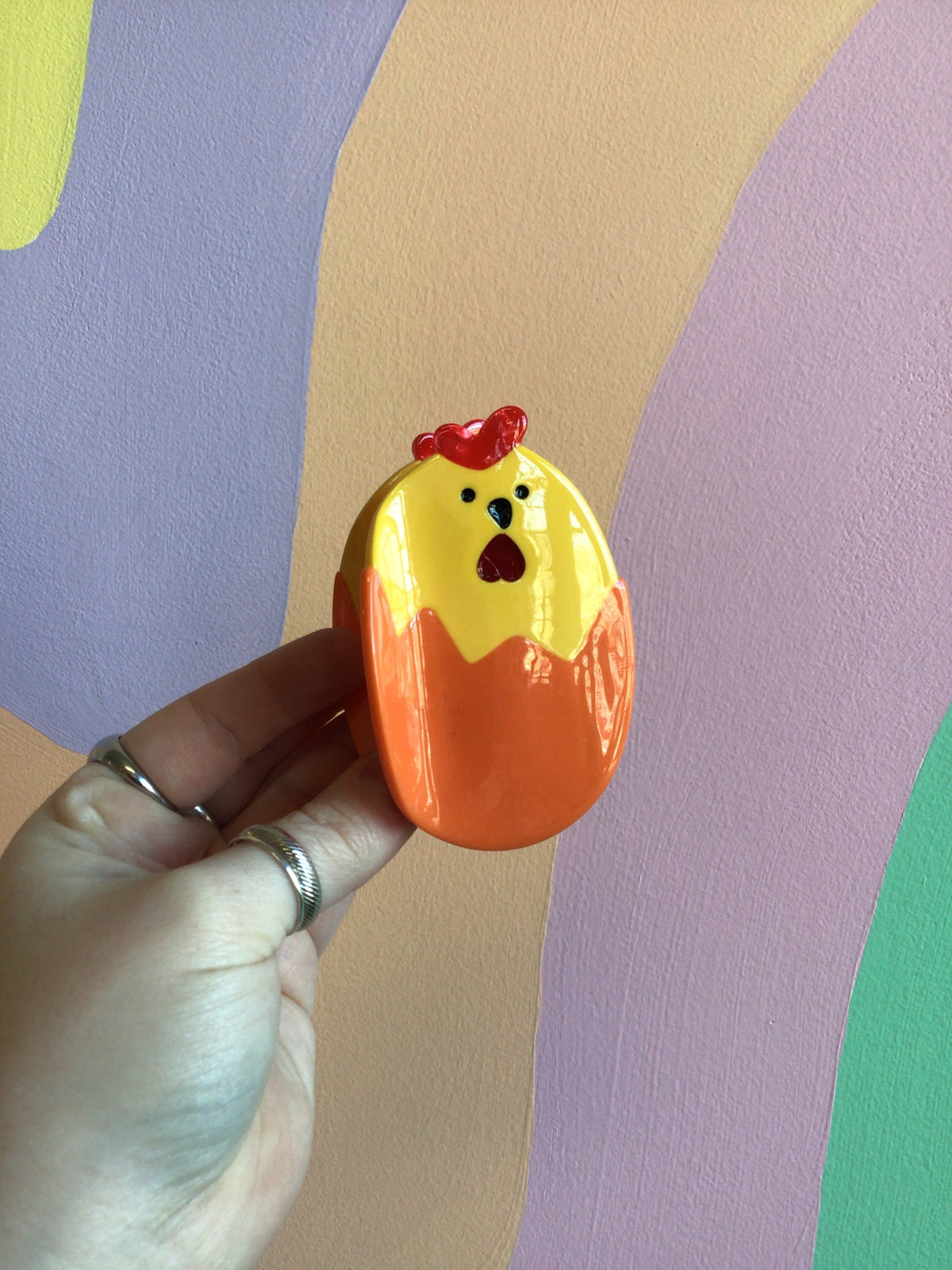 Orange chick hair claw with red beak and comb, glossy cartoon design