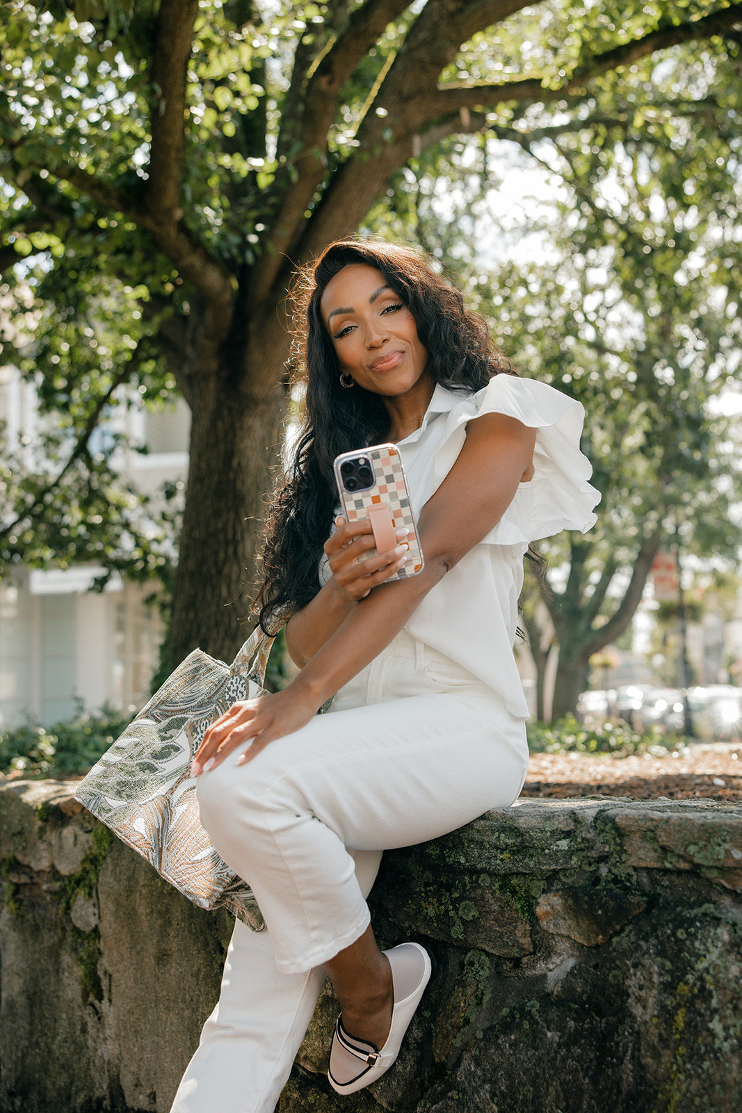 Clear checkerboard phone case with tan strap detail