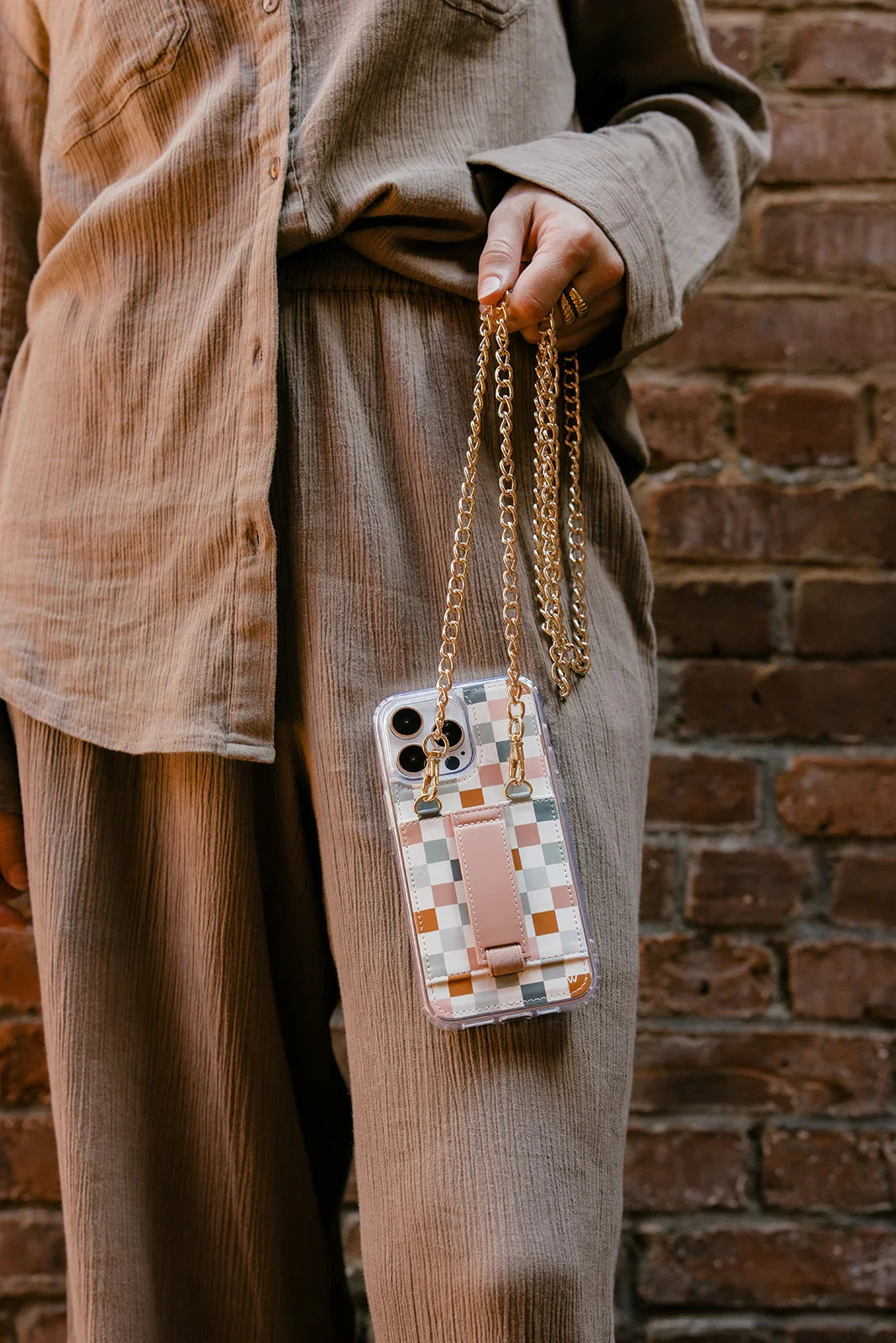 Clear phone purse case with multicolor checkered design and long gold chain handle