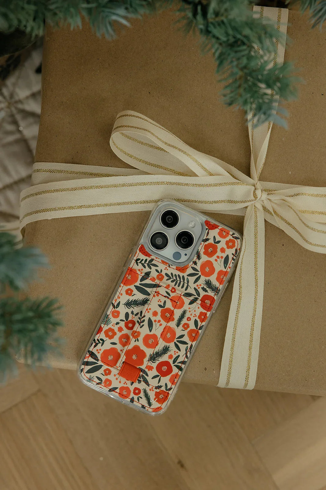 Red-and-white floral phone case tied with a beige bow
