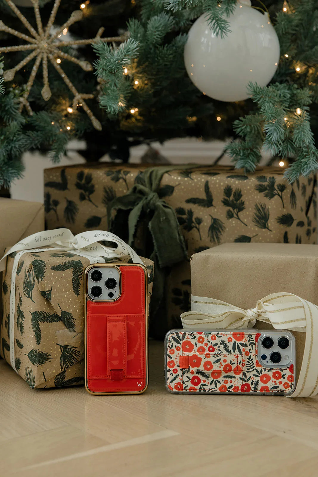 Floral phone case with red-and-white pattern beside a red phone case