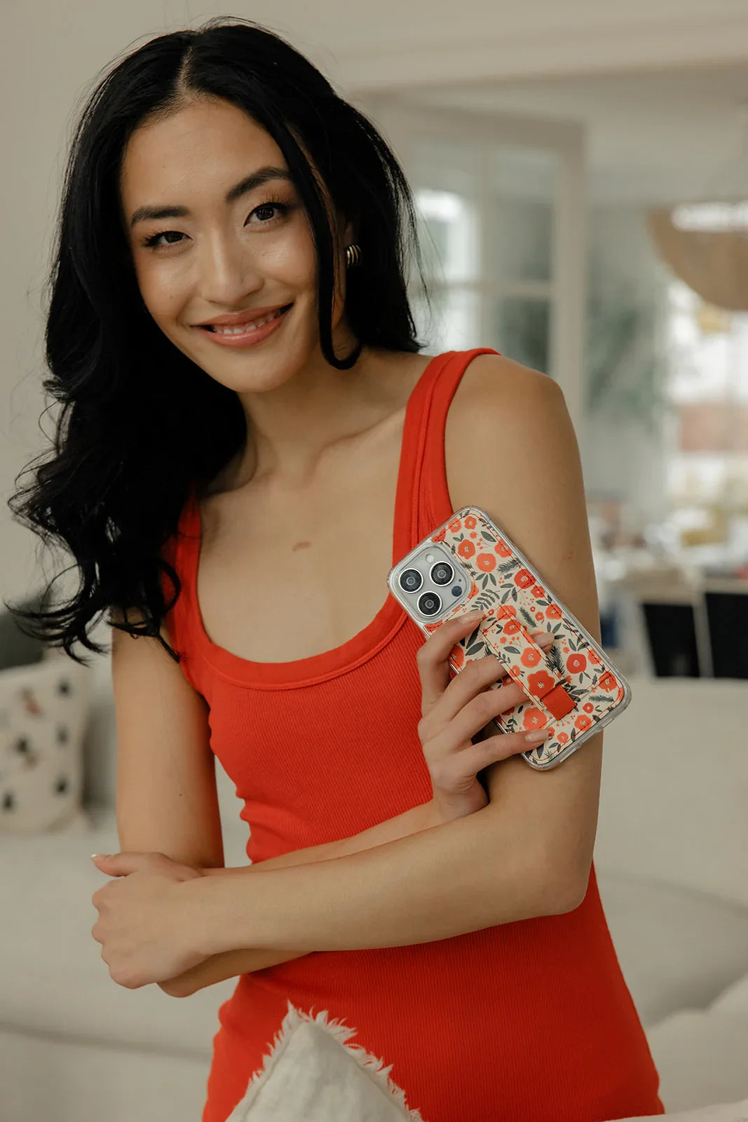 Floral phone case with red-and-white pattern and clear camera opening