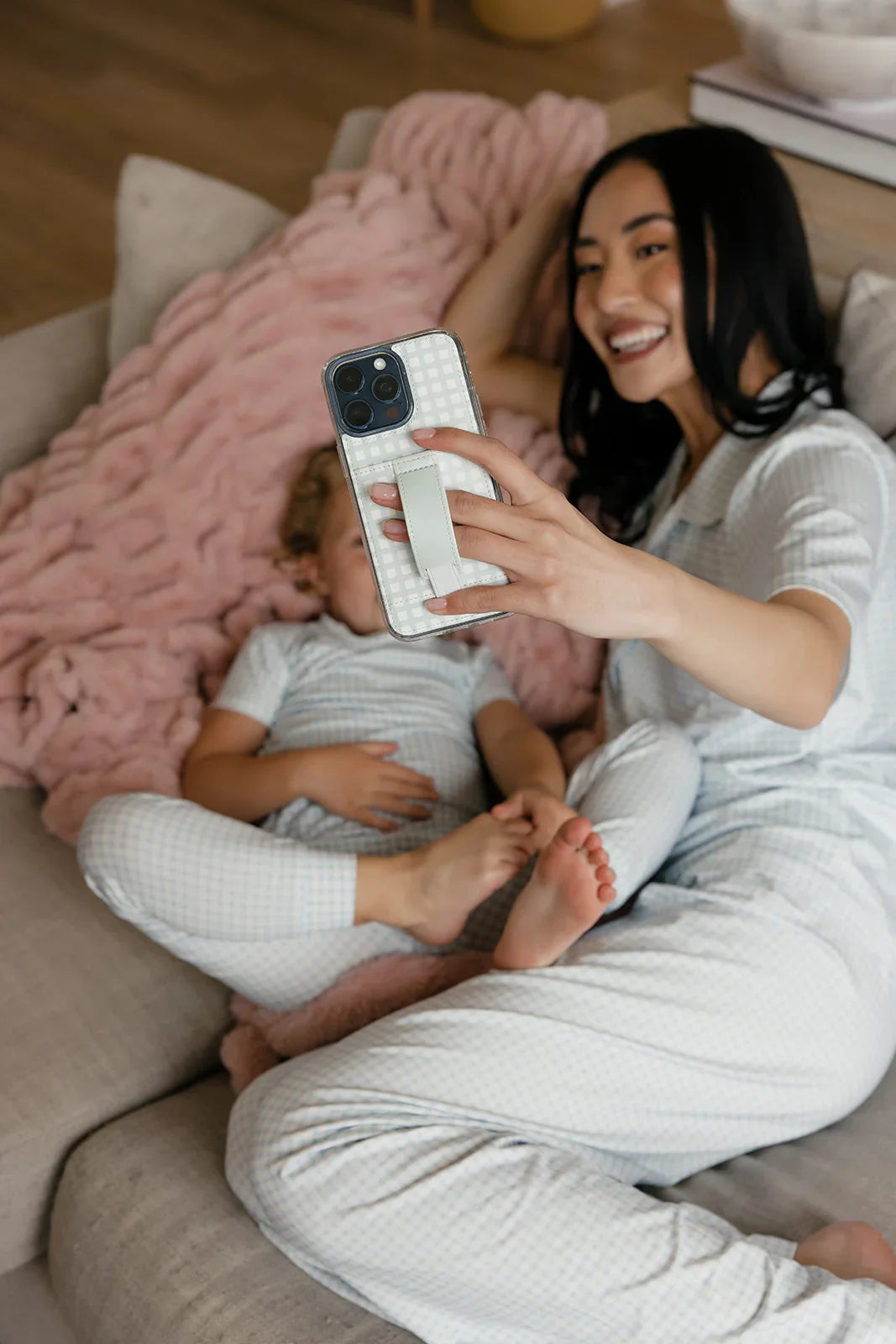 Mint gingham phone case with strap, woman holding her iPhone
