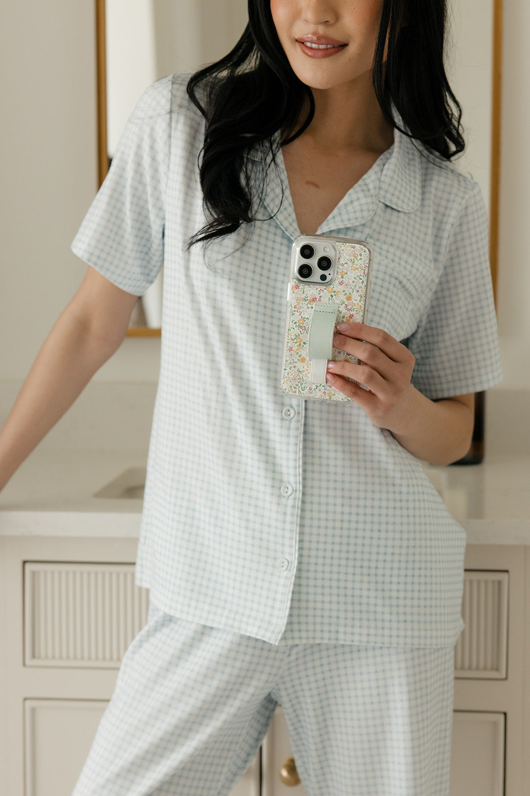 Petal Garden floral phone case with light blue strap on a phone