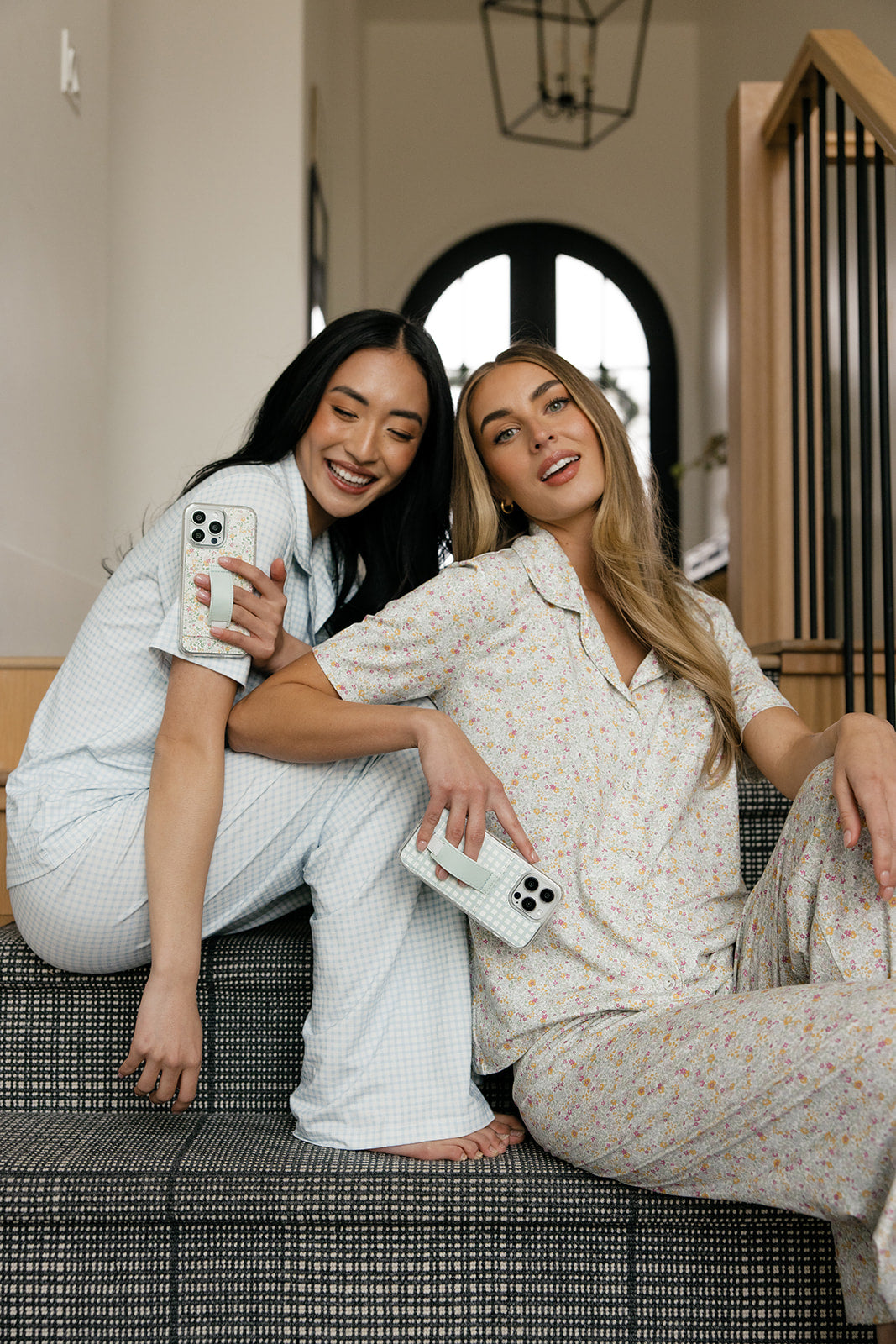 Petal Garden floral phone cases in hand by two people, wrist strap visible