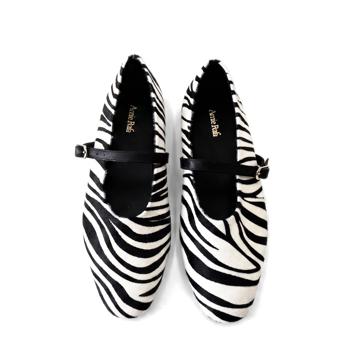 Zebra-print Mary Jane shoes with black strap and pointed loafer-style toe