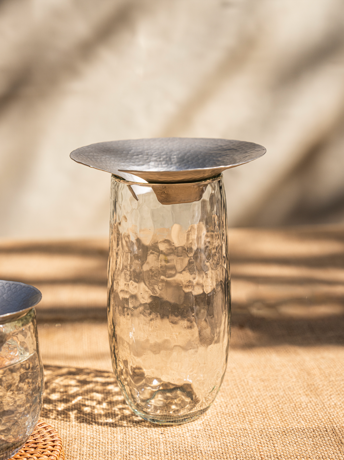 Hammered glass propagation vase with silver lid, close-up view