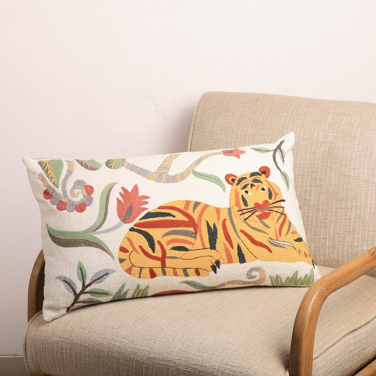 Tiger and floral pattern rectangular pillow on cream fabric upholstery