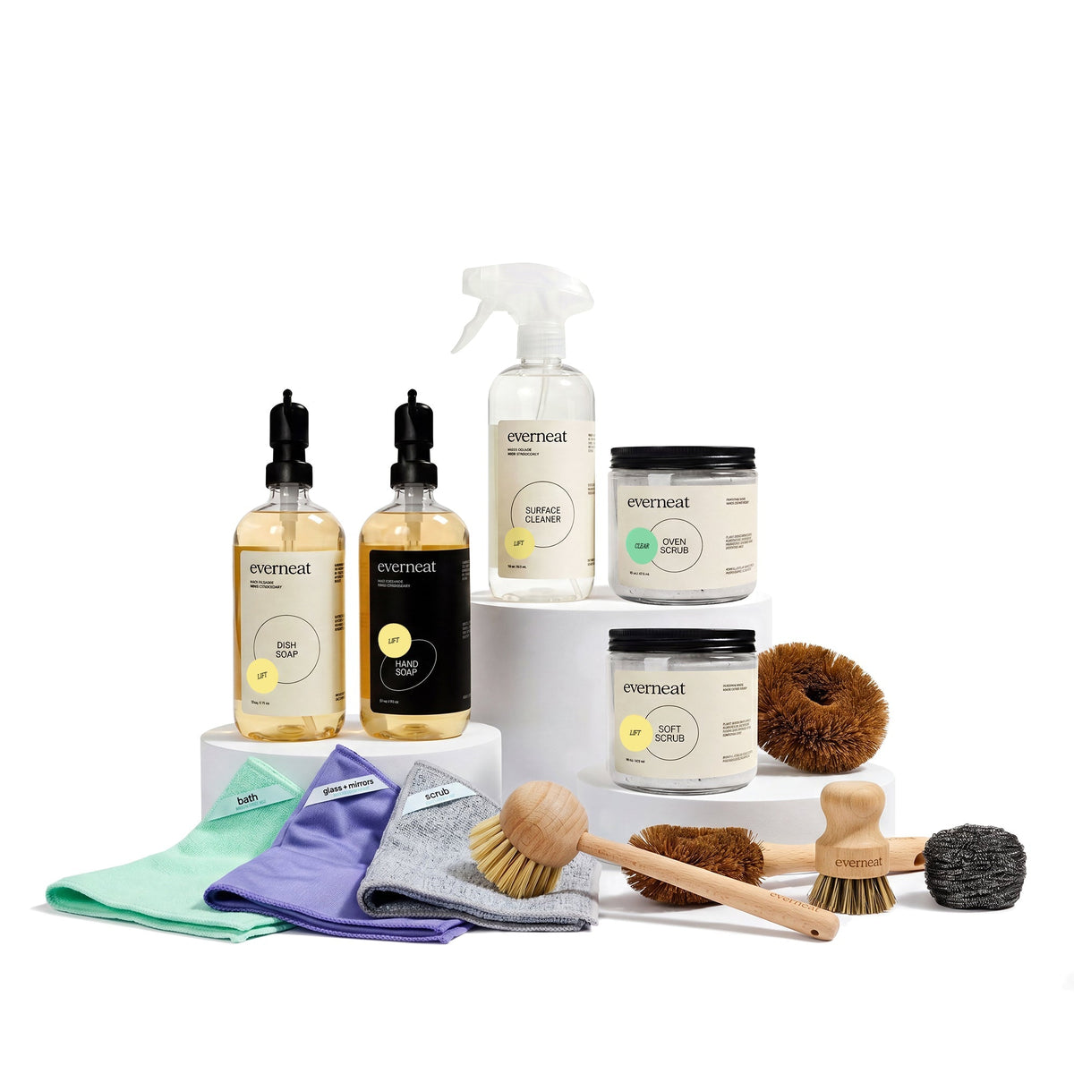 Kitchen cleaning set with bottles, jars, cloths, and multiple brushes