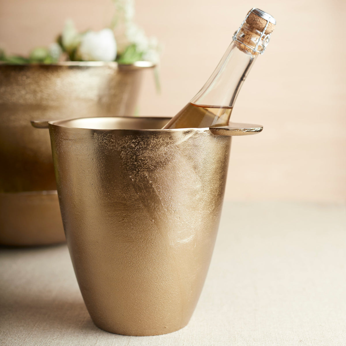 Antique brass wine chiller with bottle resting in open top