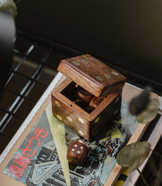 Handcrafted wood dice box set with open lid and five brown dice with pips