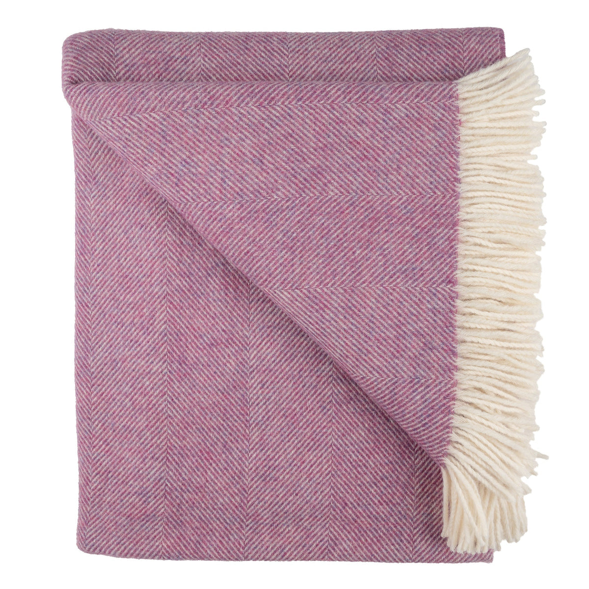 Petal pink herringbone throw blanket with cream fringes on the right edge