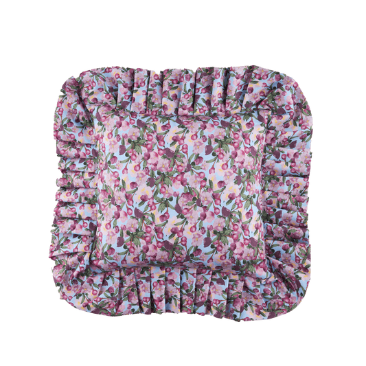 Ruffled floral pillow cover with gathered trim, pink and purple flowers