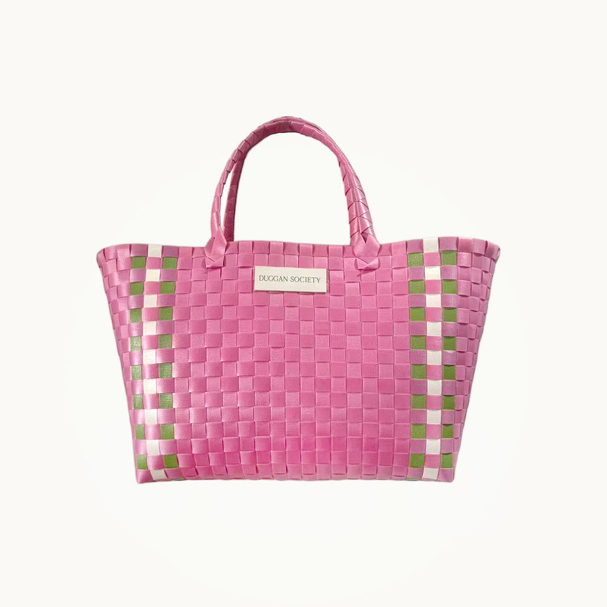 Pink woven basket bag with green check trim and label on front, woven basket weave